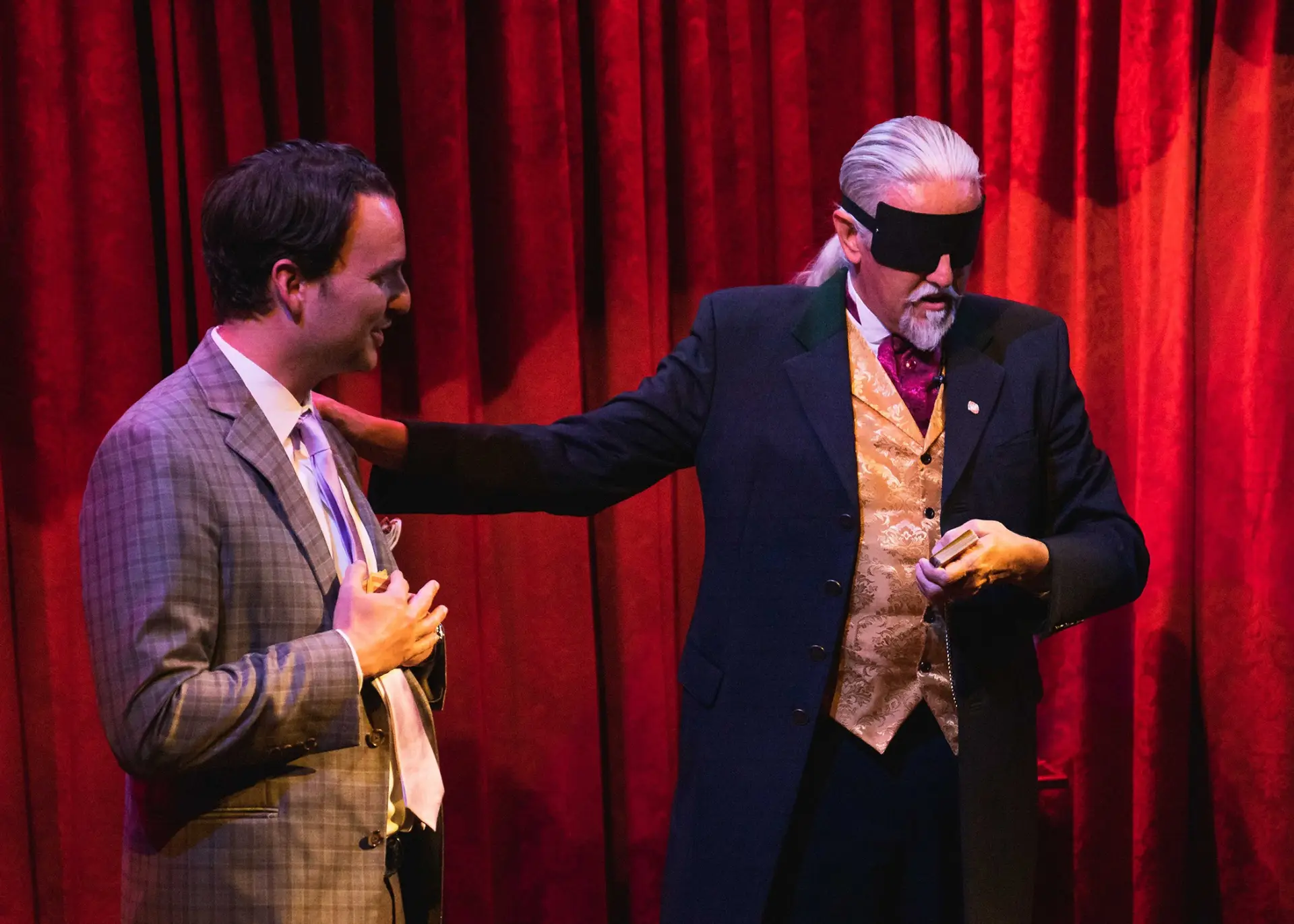 The Gentleman Wizard performs mind-reading with blindfold on stage